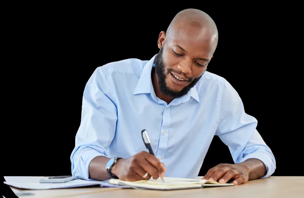 Man writing at a desk