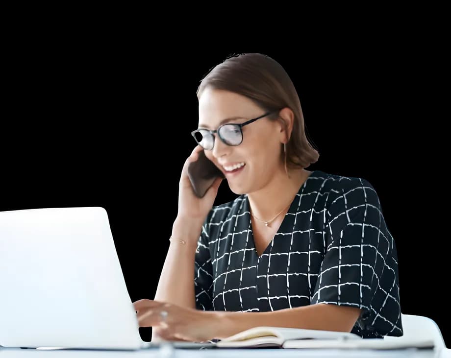 A woman on the phone at her laptop